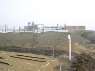 Septic field exposed in the forground. Downstairs walls are starting to climb in the background.