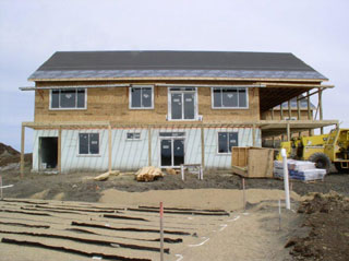 Windows, the porch framework is in place, and the septic field is back.
