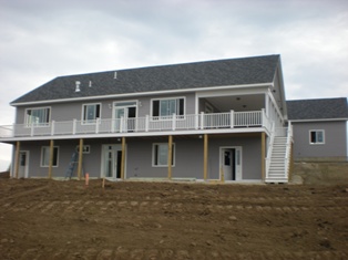 The angle has changed and now you can see part of the garage. Yard is bare dirt, but graded now.  